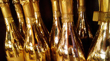 A collection of shiny wine and champagne bottles are decorated and ready to open to celebrate the New Year in style for New Year's Eve celebrations and toasting friendships, memories and a bright and hopeful future for the upcoming new year. 