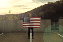 a man holding the edge of an American flag 
