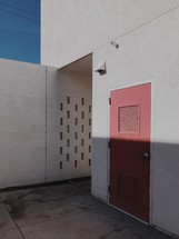 red door on a concrete building 