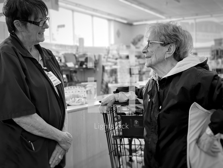 women talking in a grocery store 