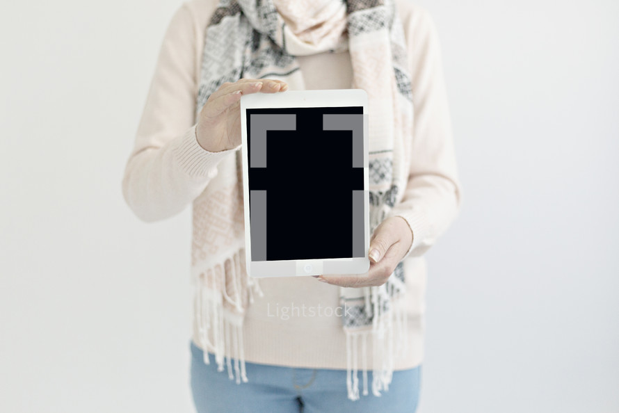 a woman holding a tablet
