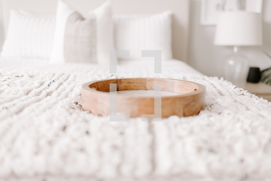 wooden tray on a bed 