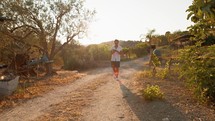 Man Walking On A Country Path Reading A Book 