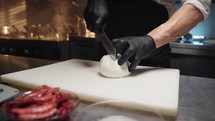 Chef cuts a DOP Campania mozzarella
