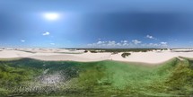 360 aerial photo taken with drone of Lagoa Azul surrounded by sand dunes at midday in Lençóis Maranhenses National Park on the northern coast of Maranhão, Brazil