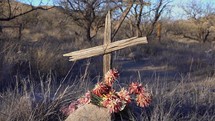 A rustic wooden cross marking an old gravesite