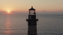 A lighthouse on the  Atlantic Ocean coast of South Carolina during sunrise 