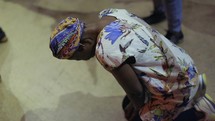 African woman kneeling to pray