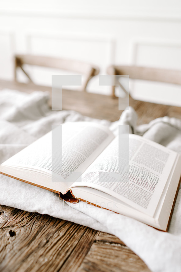 opened Bible on a white blanket 
