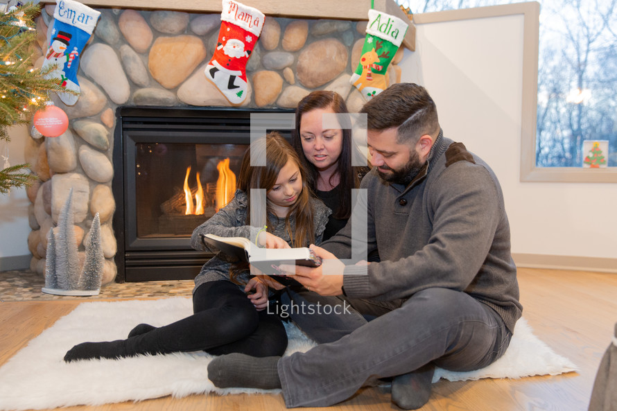 family reading a Bible together at Christmas 