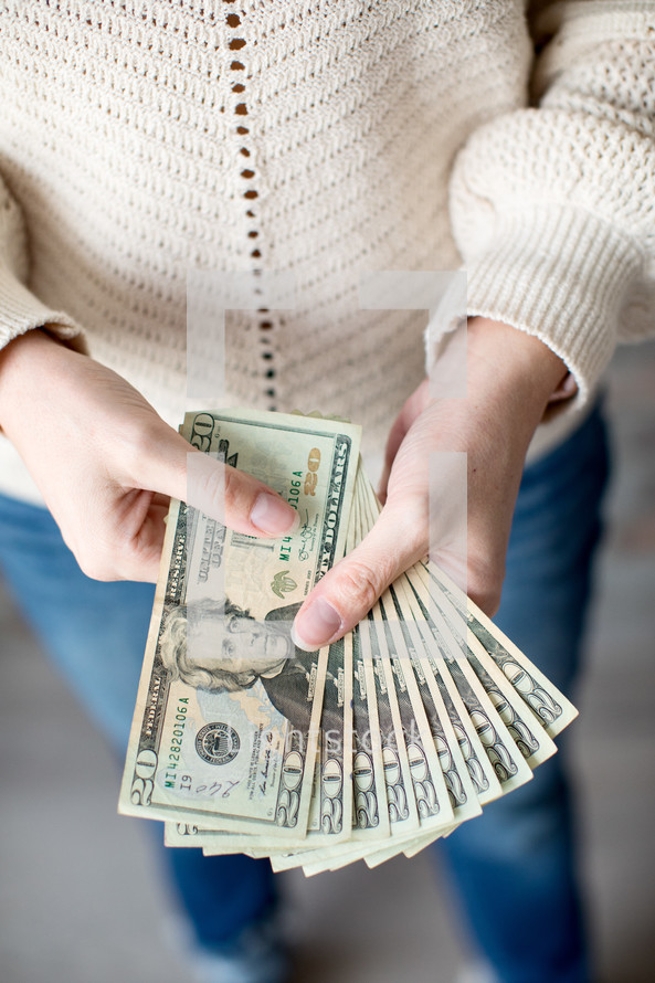 woman holding cash in hands 