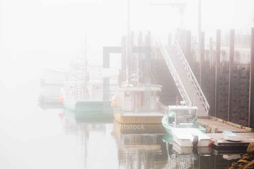 boats in a foggy port 