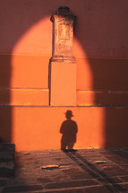 shadow of a man against a wall 