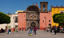 kids playing soccer in a city square 
