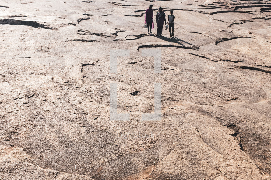 kids walking through a desert