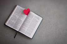 Red Heart on an open bible with copy space
