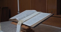 Closeup of bible in a church opened to the gospel of John.