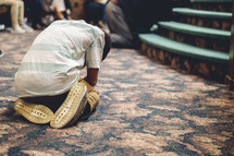 man kneeling at church 