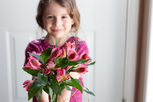a child holding Alstroemeria flowers 