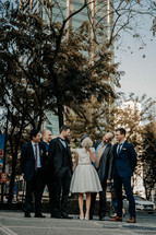 bride, groom, and groomsmen portrait in a city 