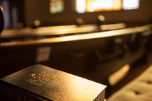 A Bible and church pews.