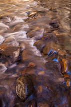 water flowing over rocks in a creek 