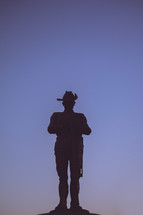 silhouette of a cowboy statue 