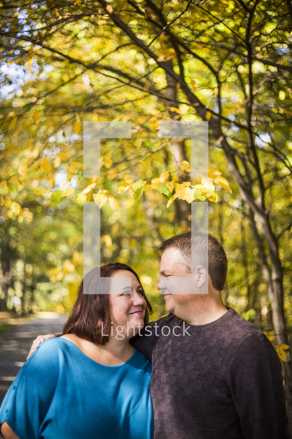a couple hugging outdoors in fall 