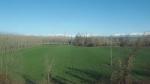 View of northern Italian countryside and Alps seen from a moving train
