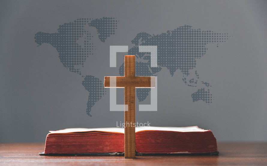 Cross and Bible in front of a map of the world