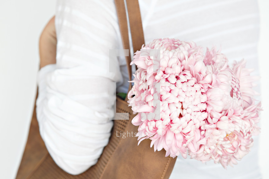 a woman with a bouquet of flowers in her purse 