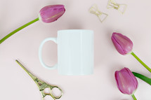 white mug, gold scissors, and fuchsia tulips 