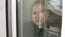 Elderly woman through a window, 