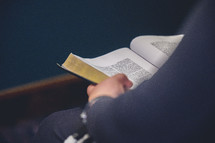 a man reading a Bible at church 