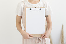 a woman holding a clipboard 