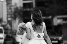 a bride walking in a city 