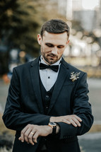 a groom looking at his watch 