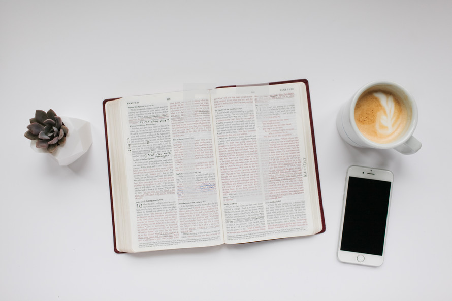 succulent plant, open Bible, phone, and latte 