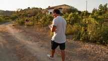 Man Finding Relax To Read While Walking In The Countryside 