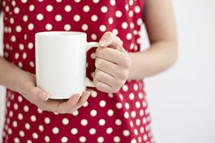 a woman holding a mug 