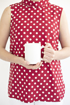a woman holding a mug 