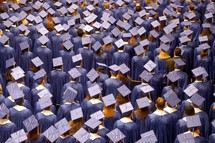 A crowd of graduates in cap and gown
