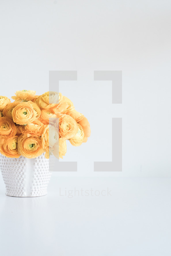 yellow flowers in a white vase 