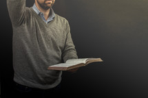 a preacher holding a Bible during his sermon 