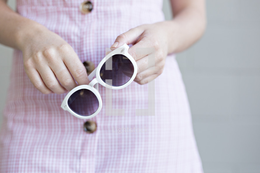 woman holding sunglasses 