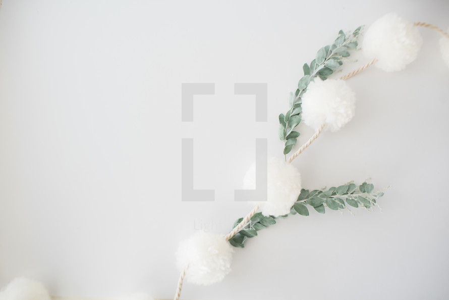 eucalyptus and twine with white puff balls 