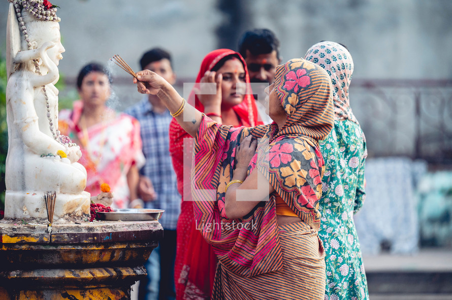 Group of women praying to idols and guards at the Narasimha Hindu temple in Visakhapatnam, India