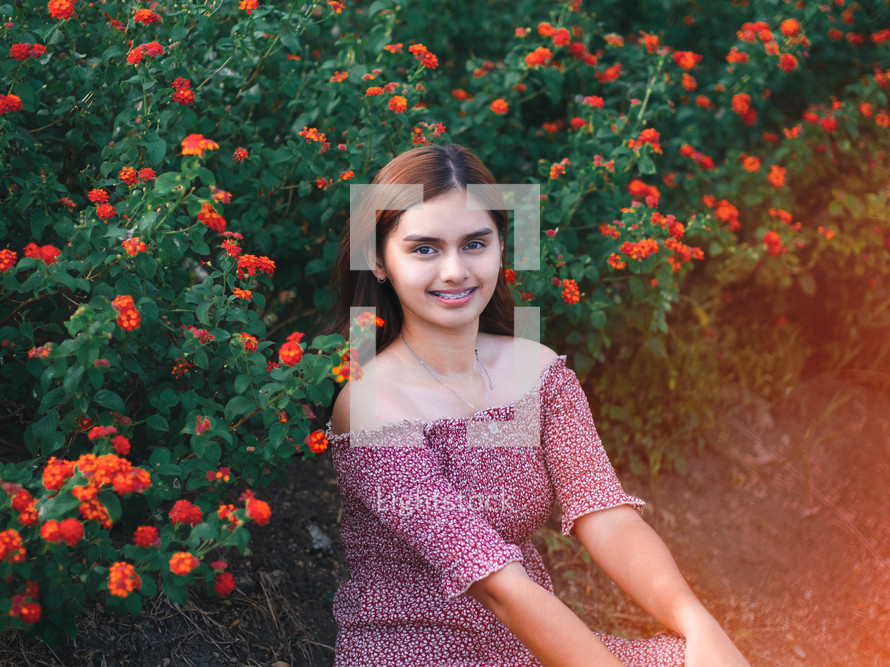 a teen girl in a field of flowers 