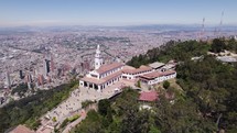 Drone shot circling the Monserrate Sanctuary, sunny day in Bogota, Colombia