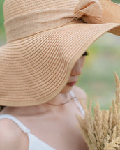a young woman in a sunhat 